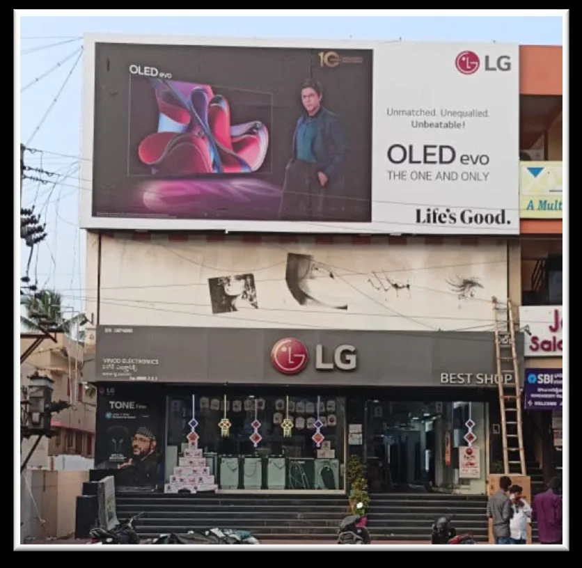 LG OLED evo building hoarding above a Tirupati electronics showroom